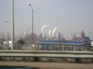 Steel mills with smoking stacks seen from a road on the Hamilton waterfront