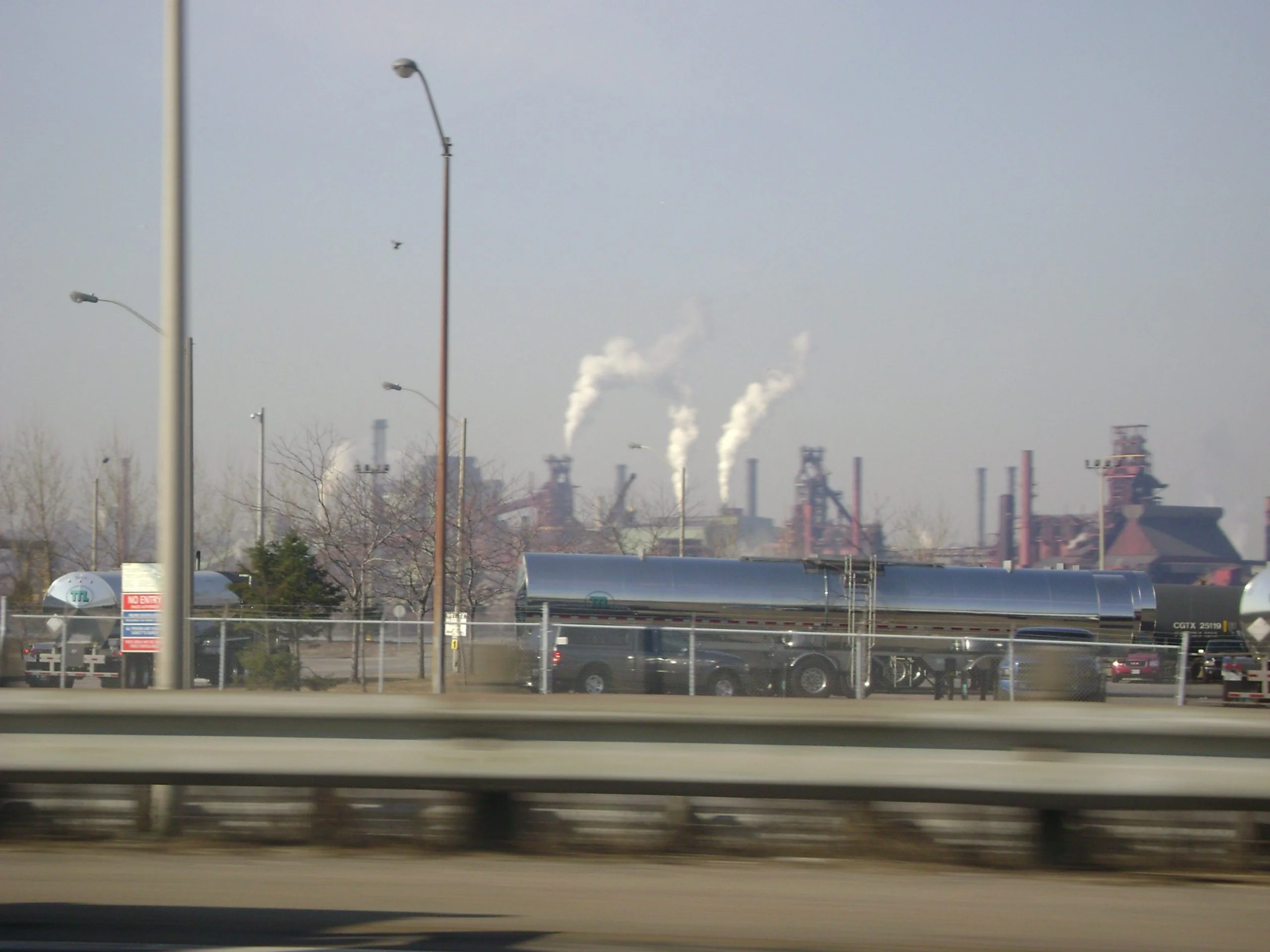 Steel mills on the Hamilton waterfront Steel mills with smoking stacks seen from a road on the Hamilton waterfront