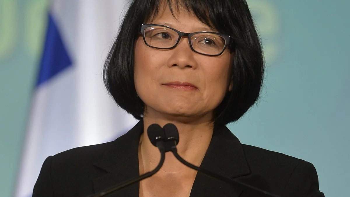 Olivia Chow speaking at a podium during an all-candidates debate