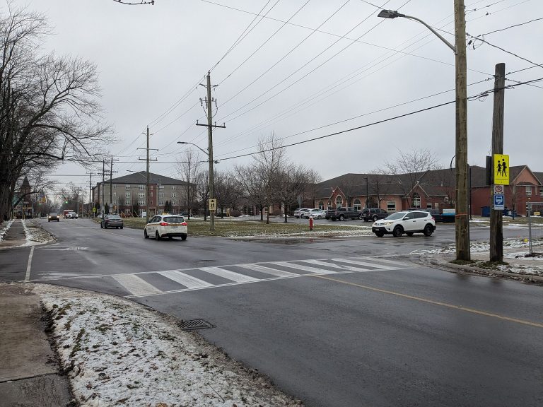 A school crossing sign at an intersection in Ontario