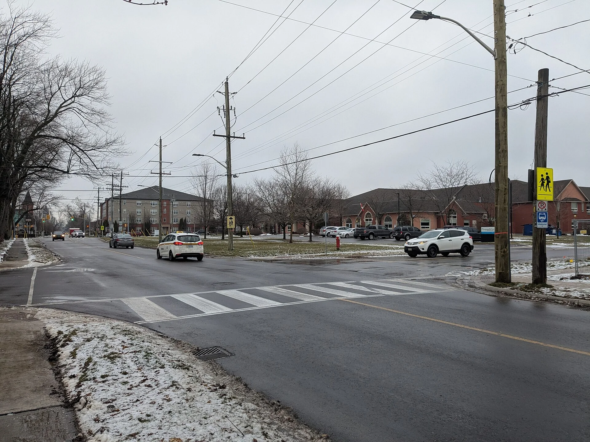 A school crossing sign at an intersection in Ontario