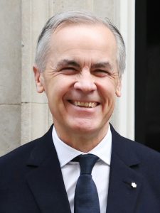 Prime Minister Mark Carney in a dark suit and tie, photographed outside 10 Downing Street