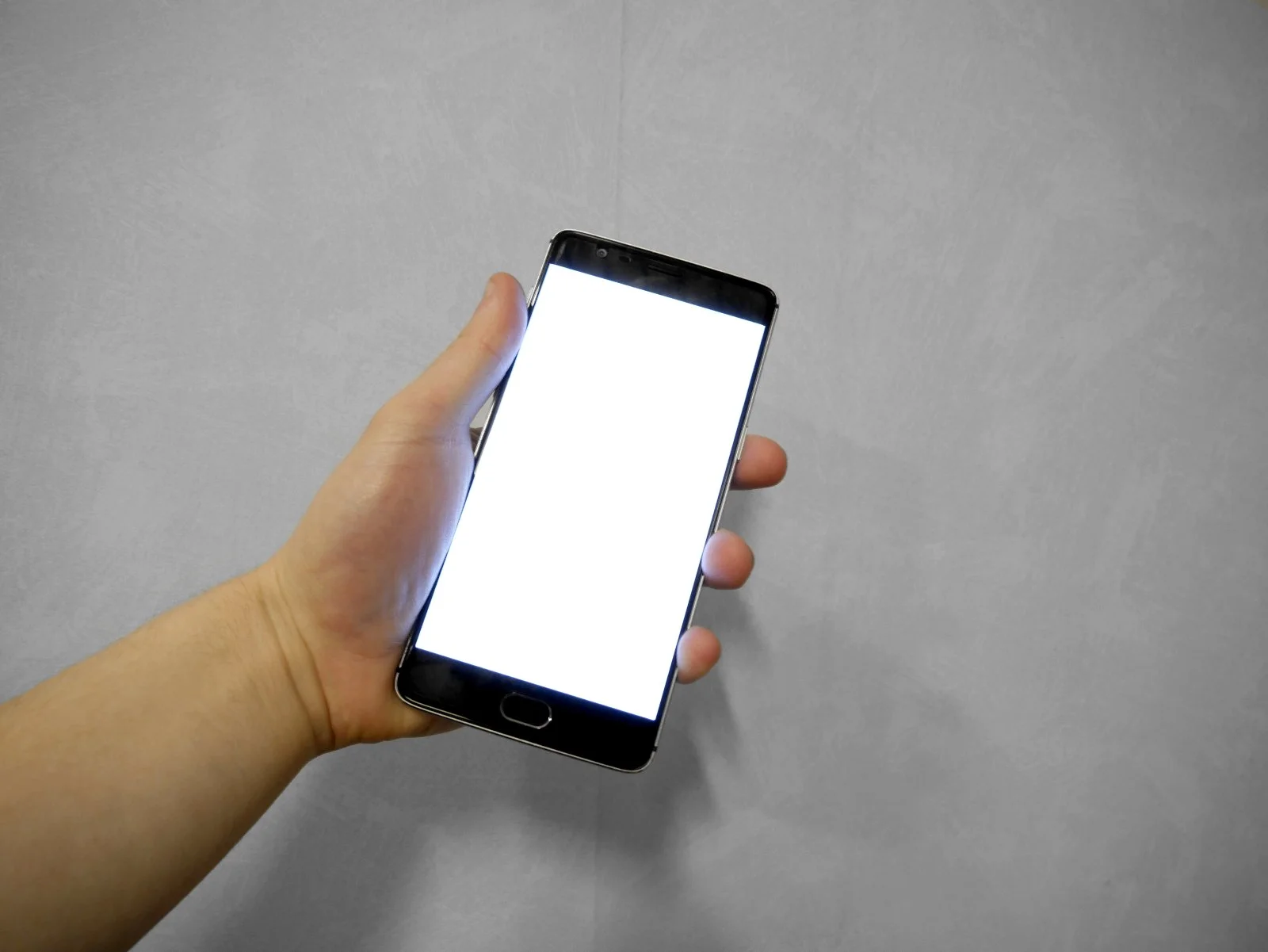 Smartphone A hand holding a smartphone with a blank screen