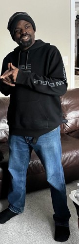 A full-length Toronto Police Service handout image of the missing 44-year-old man, wearing a dark hooded top and jeans.