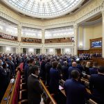 Members of Ukraine’s parliament standing in the domed Verkhovna Rada session hall in Kyiv