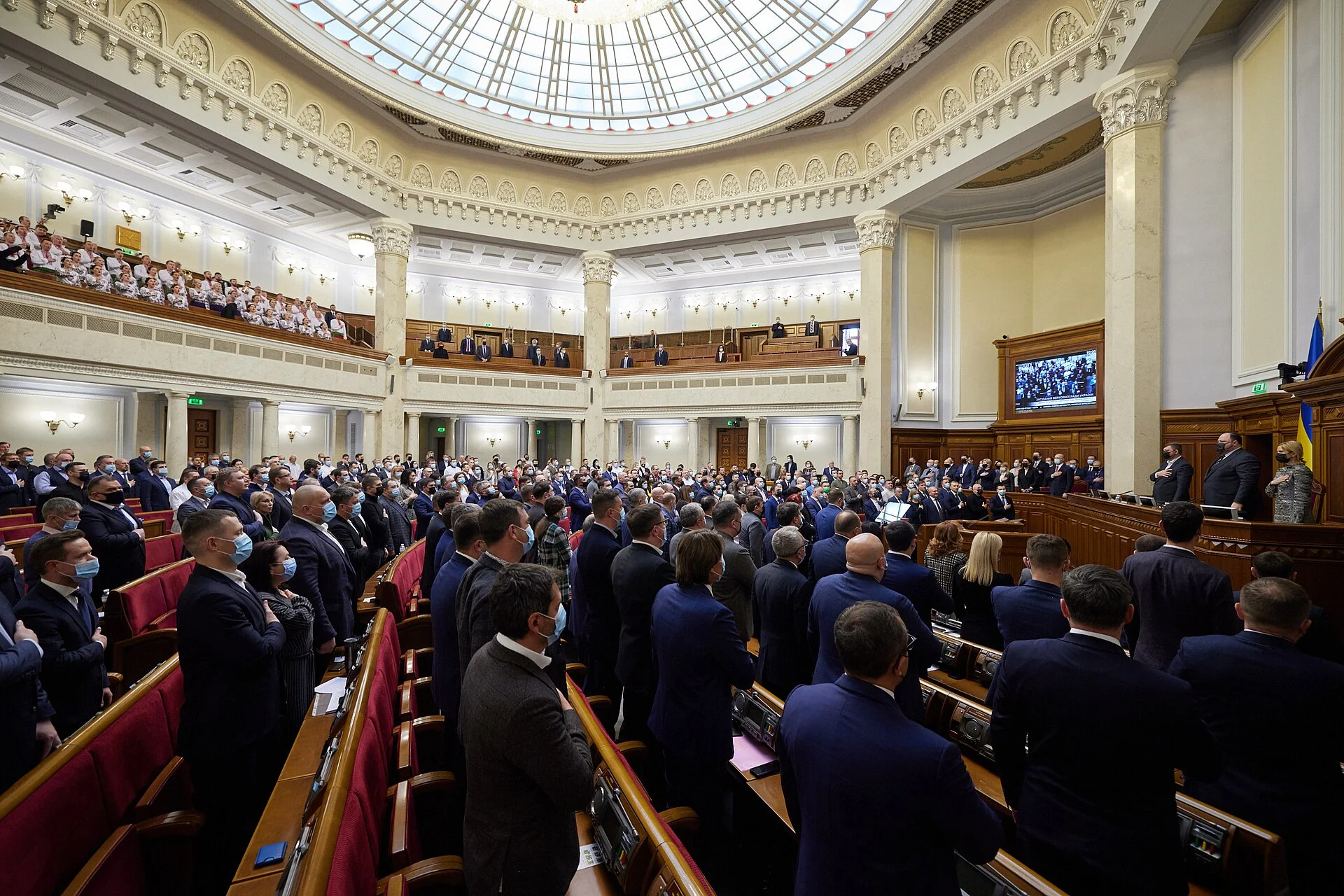 Members of Ukraine’s parliament standing in the domed Verkhovna Rada session hall in Kyiv