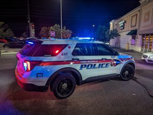 A marked York Regional Police SUV with its emergency lights on at night