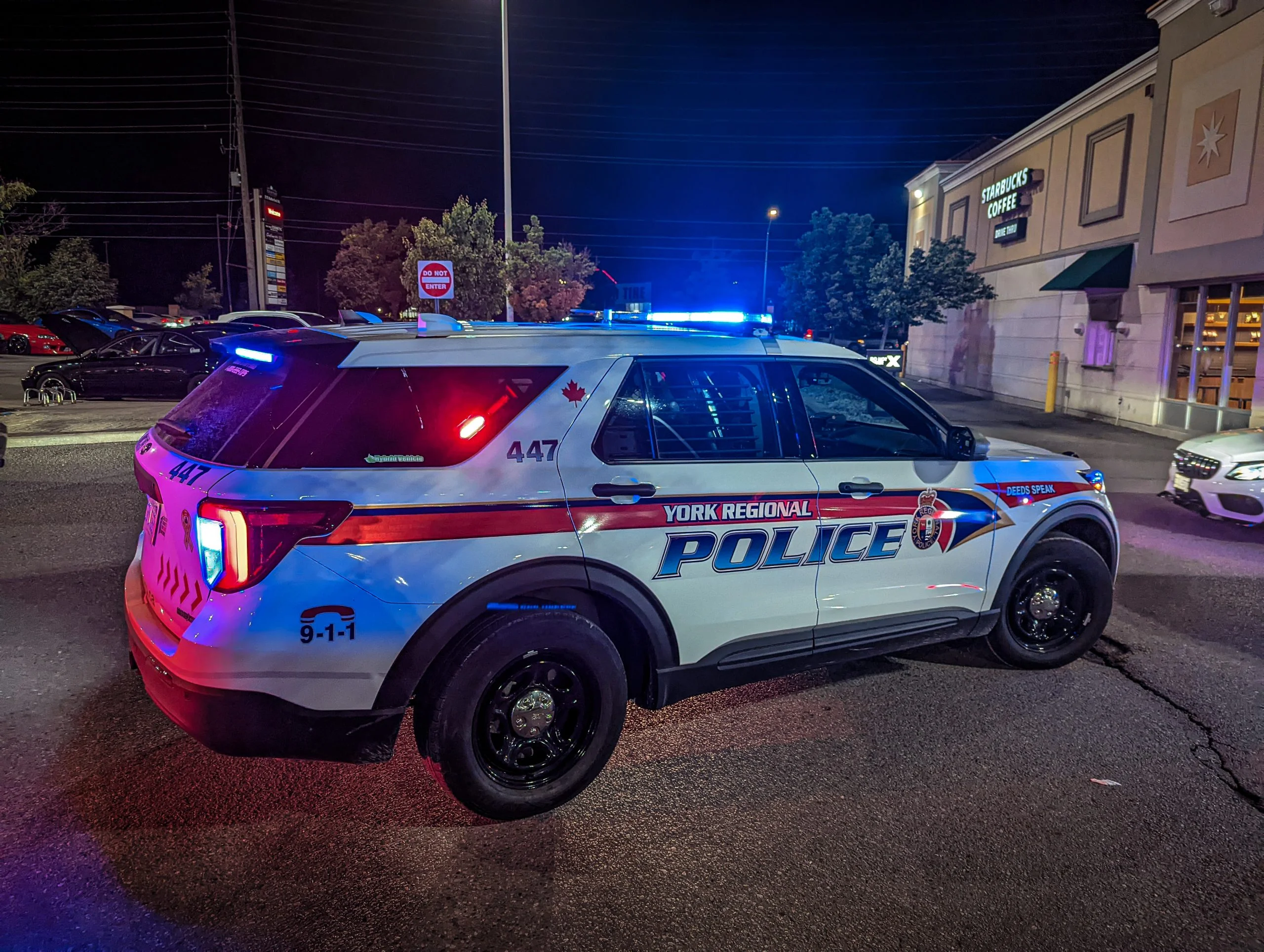 A marked York Regional Police SUV with its emergency lights on at night